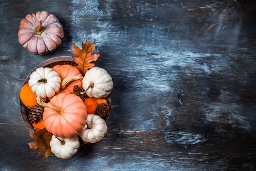 Thanksgiving and Halloween concept. Pumpkins and autumn leaves.