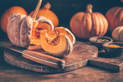 Pieces with ripe pumpkin seeds on a cutting board, prepared for cooking