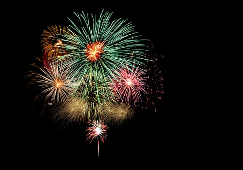 Fireworks light up the black sky with dazzling fireworks exploding display