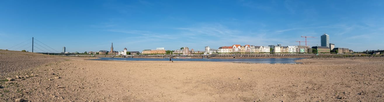 DUSSELDORF, GERMANY - AUGUST 11, 2022: Low water of the Rhine river in Dusseldorf, drought in North Rhine Westphalia on August 11, 2022 in Germany