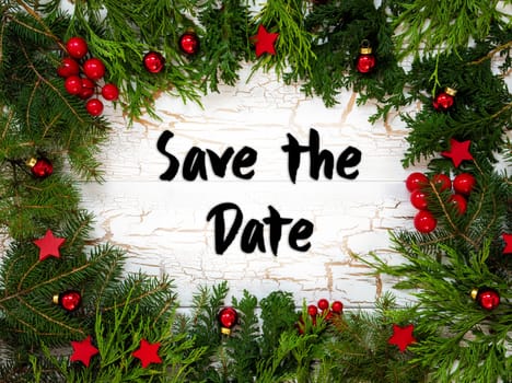 Christmas Card With Fir Branches And English Text Save The Date. White Wooden Background With Vintage Design And Christmas Decoration Like Red Ornament Balls.