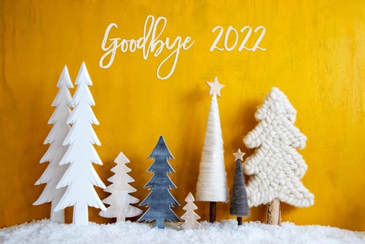 Christmas Trees With English Calligraphy Goodbye 2022. Yellow Wooden Rustic Background With Snow. Christmas Decoration With Stars.