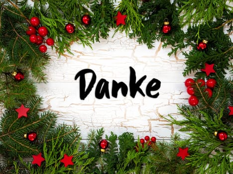 Christmas Card With Fir Branches And German Text Danke Means Thank You. White Wooden Background With Vintage Design And Christmas Decoration Like Red Ornament Balls.