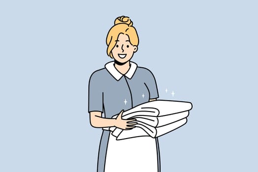 Smiling housekeeper in uniform holding stack of towels. Happy female housemaid or janitor working in hotel. Housekeeping concept. Vector illustration.