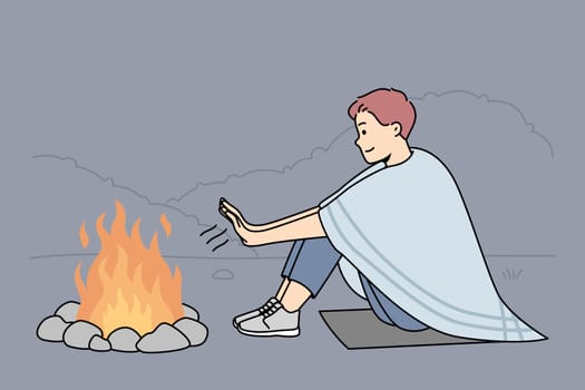 Young man sit on ground in nature warm hands at campfire at night. Smiling male relax on hiking trip in forest near fire. Vector illustration.