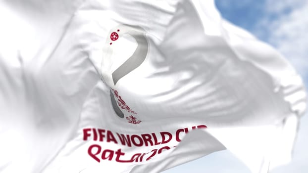 Doha, QA, October 2022. Close-up view of the FIFA Qatar 2022 World Cup flag waving in the wind. The World Cup will take place in Qatar from 20 November to 18 December 2022
