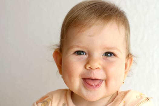 Small baby laughing on the bright background
