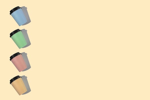 Four multi-colored cardboard coffee cups with a plastic lid on a beige background. Template with copy space. The concept of ecology, recycling, environmental protection.