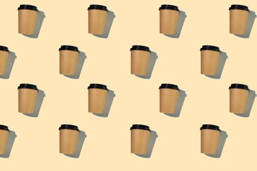 Pattern of cardboard coffee cups with a plastic lid with a hard shadow on a beige background. The concept of ecology, recycling, environmental protection.