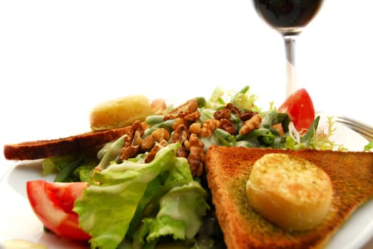 Healthy lunch of green salad with toast and goat cheese