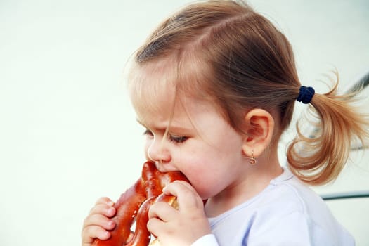 Small child eating a pretzel