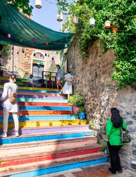 Istanbul, Turkey - August 28 2022: Tourists visiting famous traditional cafe decorated with multicolored panels and colorful stairs, suited in Balat District