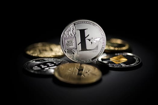 Bitcoin and cryptocurrency investing concept. Litecoin cryptocurrency coins in black background.