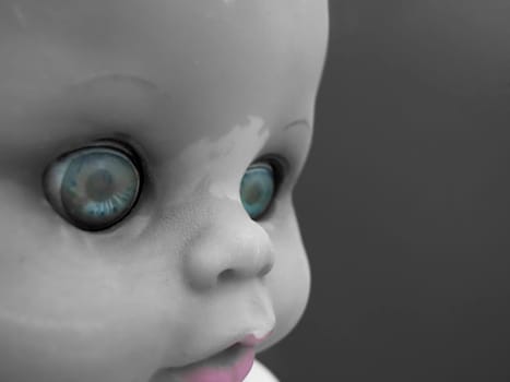 Portrait of an old doll with selective color