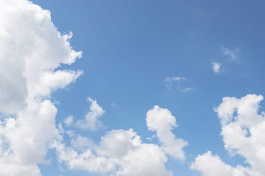 Blue sky background with white clouds. Concept of peace and tranquility.