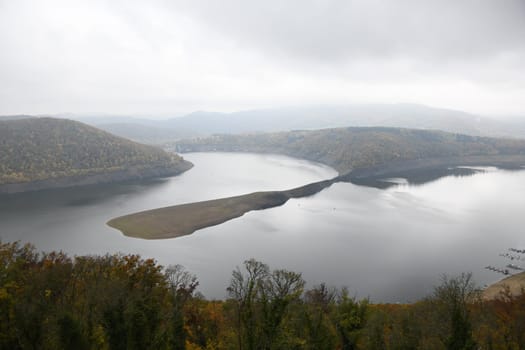 The Edertalsee in autumn with clouds. The reservoir is located in Germany in the state of Hesse. The Edertalsperre was built to keep the river Weser navigable.