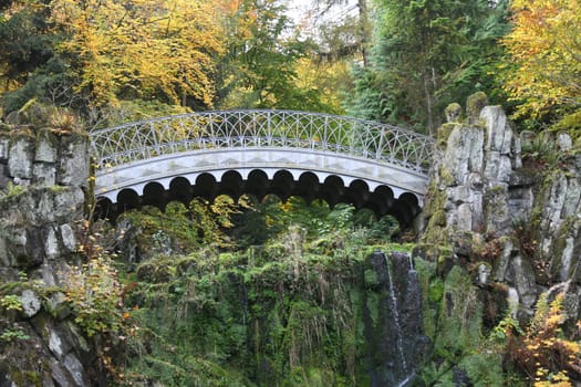 The devils bridge in the Bergpark Wilhelmshöhe in the city of Kassel in Hesse spans the Höllenteich. In 1826 the lattices of the bridge were cast from solid metal. A popular destination