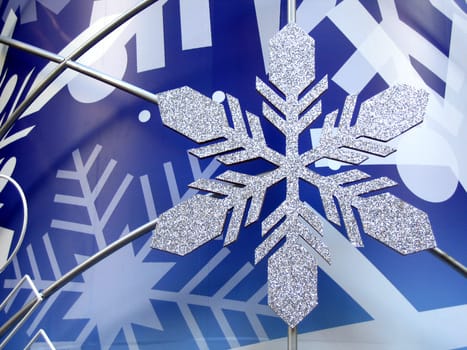 Shiny snowflake in blue background