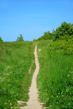Narrow small pathl with the view in the blue sky