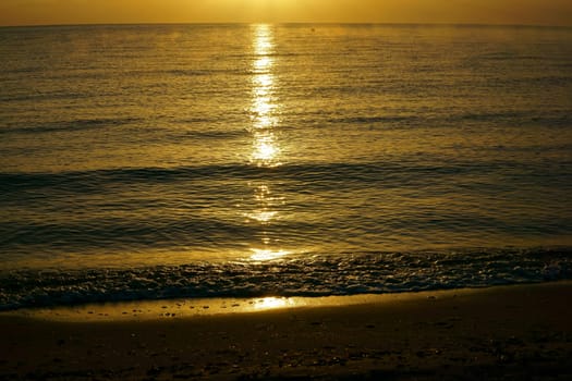 Sunrise over the baltic sea with reflections on water surface