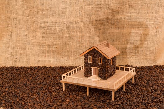 House made of coffee on juta background