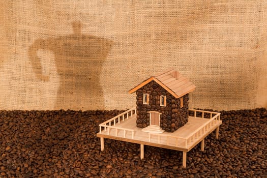 House made of coffee on juta background