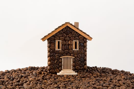 House made of coffee on white background