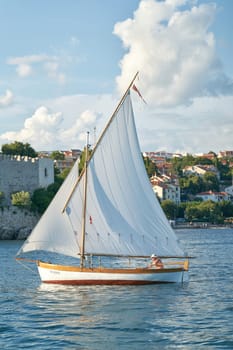 Sailboat in front of the town of Krk on the island of the same name on the Adriatic Sea in Croatia