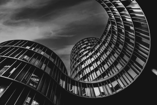 Low angle shot of Axel Towers Copenhagen on a cludy day in Copenhagen, Denmark. Axel Towers Copenhagen is an abstract contemporary architectural office building and consists of five cylindrical towers consisting of metal, copper and glass.