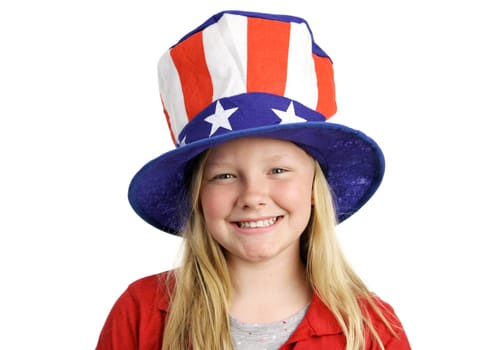 A pretty blond little girl smiling in a stars and stripes hat for Fourth of July.  Isolated on white.
