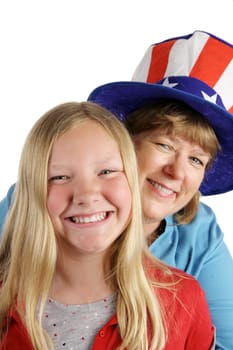 A cute american girl and her mother dressed for the Fourth of July holiday.  Isolated on white.