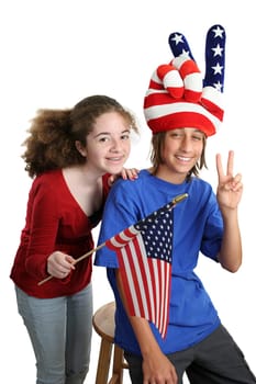 Two teens celebrating American Independence Day with patriotic hat and US flag.  Isolated.