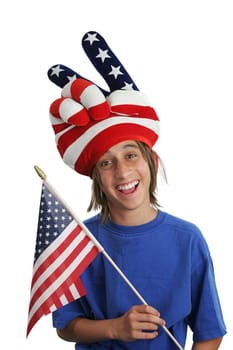A teen boy in a USA patriotic hat holding a flag and making a silly face.