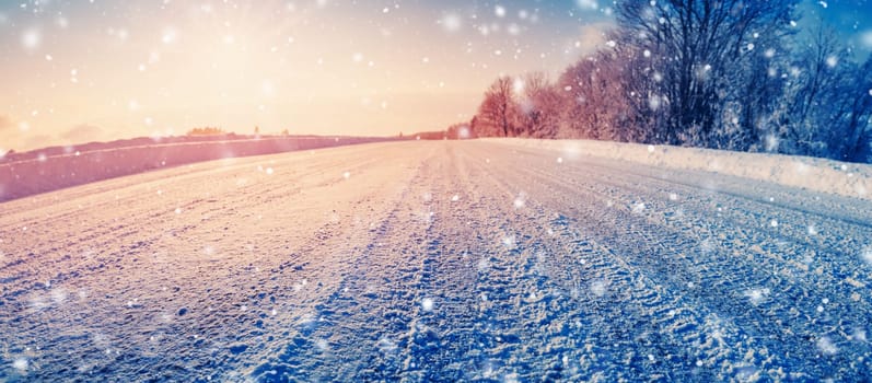 Closeup view of the snowy dirty road insnowstorm in natural park. Beautiful winter background.