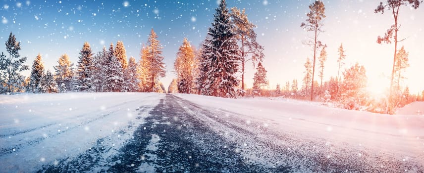 Beautiful winter road in natural sunny park. Panoramic view of the snowy street.