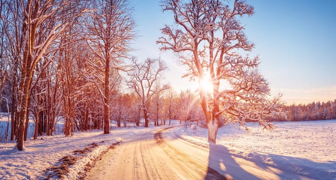 Beautiful view of the sunrise in the morning on the country snowy road. Scenery landscape.