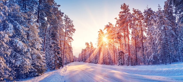 Beautiful view of the sunrise in the morning on the country snowy road. Scenery landscape.