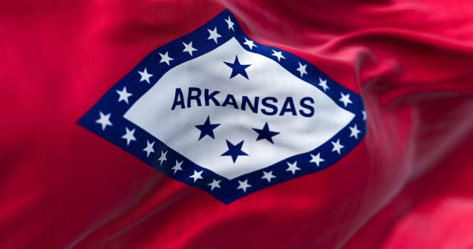 Close-up view of Arkansas state flag waving. Arkansas is a United States state. Fabric textured background. Selective focus