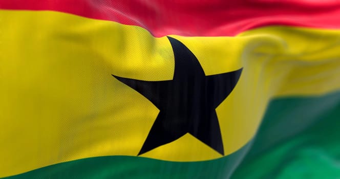 Close-up view of Ghana National flag waving. The Republic of Ghana is a West African state. Fabric textured background. Selective focus