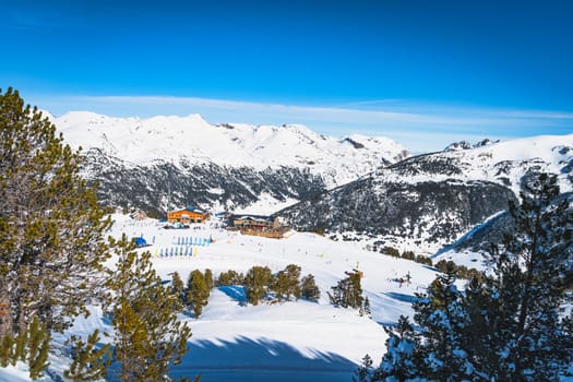 People, families, skiers and snowboarders relaxing and having fun in winter at Soldeu ski lifts cross centre, Grandvalira, Andorra, Pyrenees Mountains