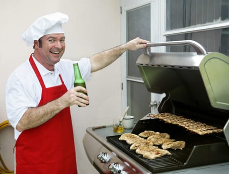 A happy smiling cook making dinner on his barbecue grill.