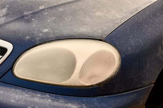 the front headlight of the car covered with frost. High quality photo