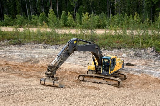 Excavator digs the ground. High quality photo