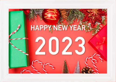 Happy New Year 2023 background. Banner Christmas gifts and decorations with 2023 years number on red background, Flat lay, top view, copy space