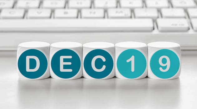 Letter dice in front of a keyboard - December 19
