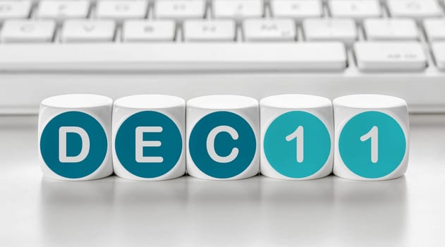 Letter dice in front of a keyboard - December 11