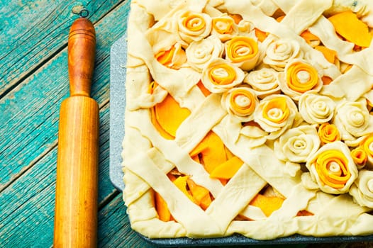 Making traditional pumpkin pie, raw pie.Rustic table