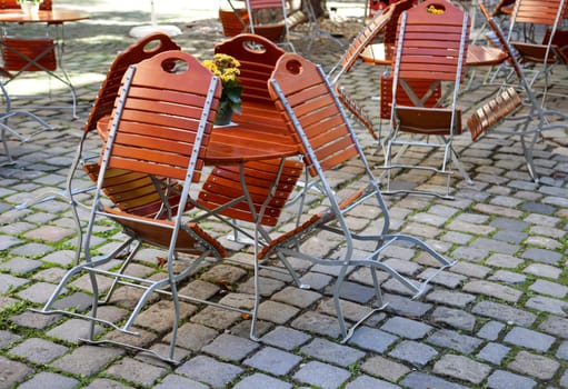 Early in the morning in a beer garden. The chairs and tables are not yet properly set up.