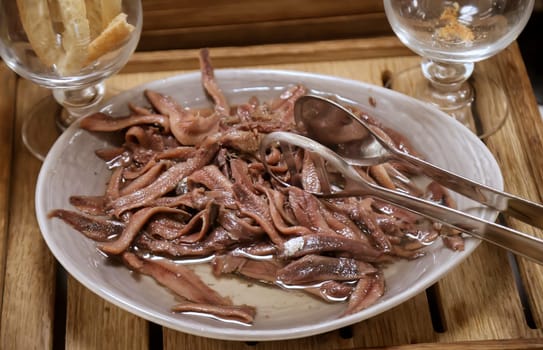 Small fish, similar to sprats in a bowl on a buffet.