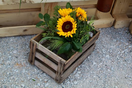 A festive decoration with beautiful yellow sunflowers.